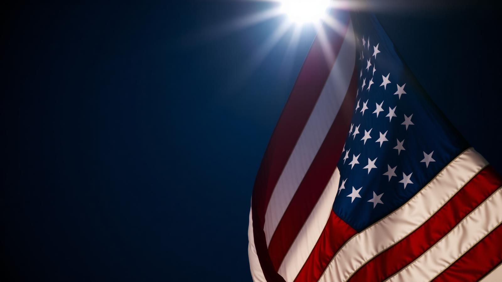 American flag illuminated against a deep navy sky